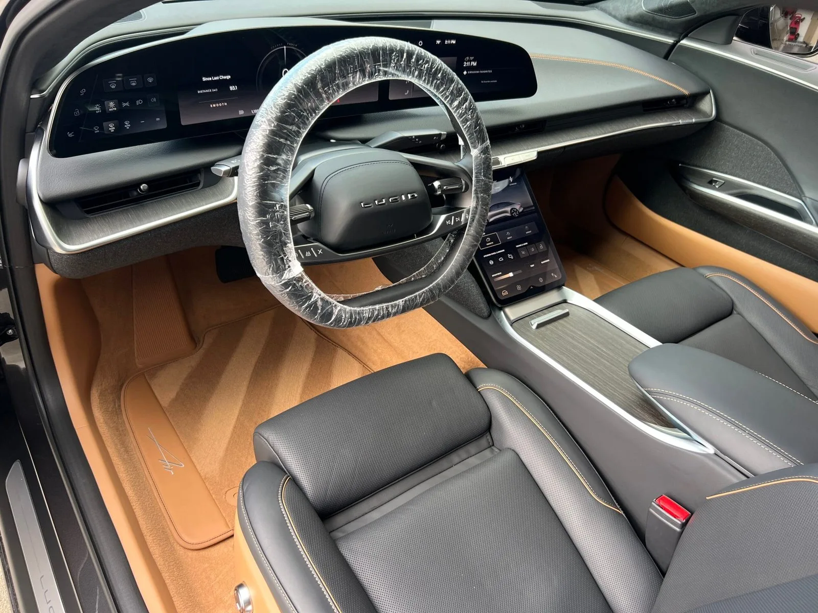 Interior detailing result showing cleaned front seats and center console