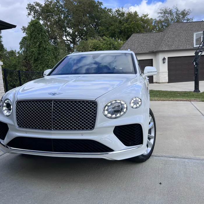 White Bentley Bentayga after a detail, on a driveway in Sienna