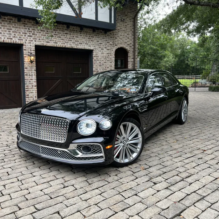 Black Bentley Flying Spur after a detail, on a cobblestone driveway in River Oaks