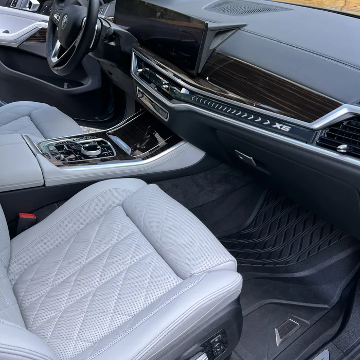 BMW X5 front seat and dashboard with light gray leather after an interior detail
