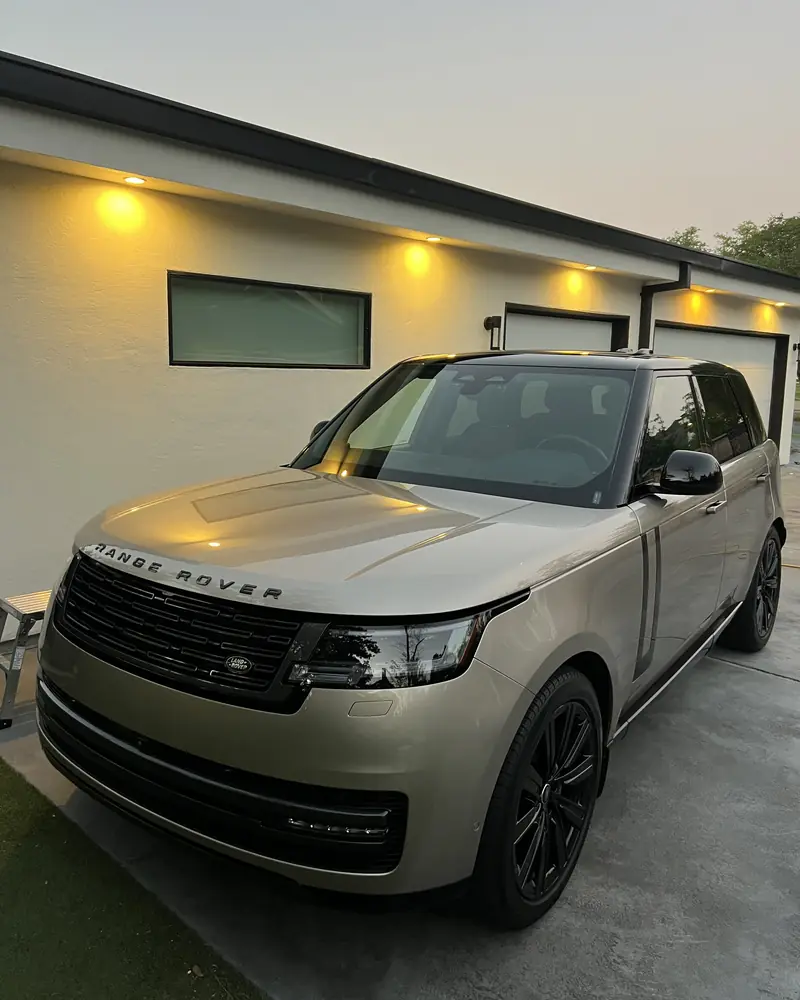 The same Range Rover after coating, with the garage lights reflected in the paint