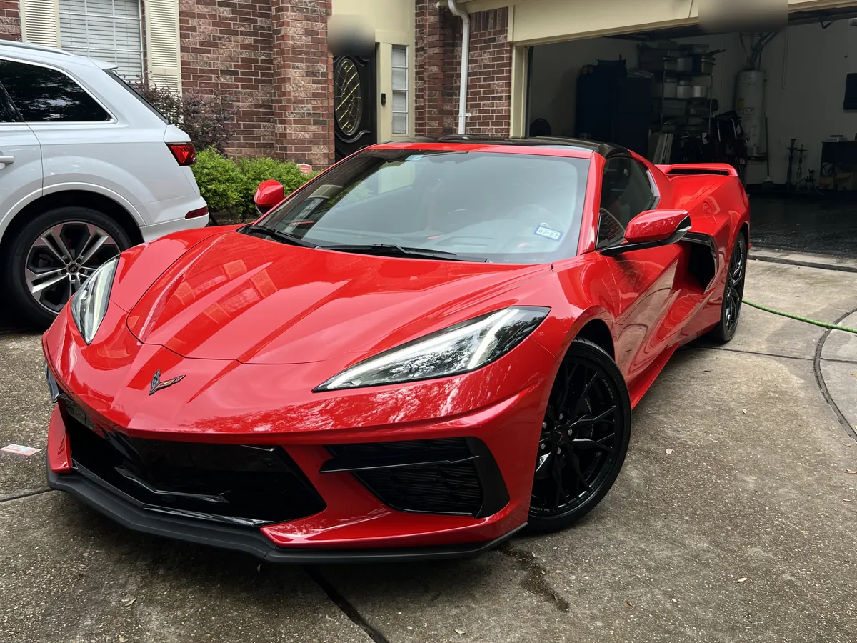 Red Chevrolet Corvette C8 after an Azul detail, parked in a Sugar Land driveway