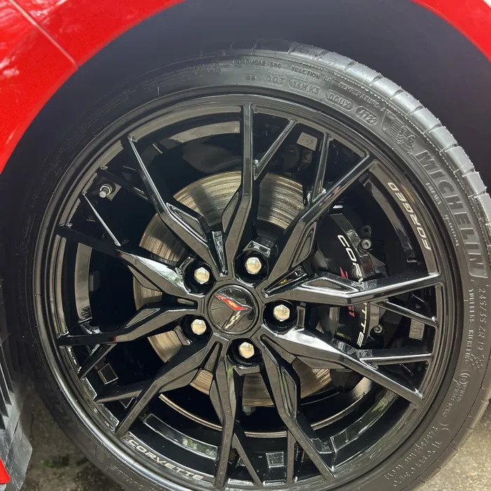 Chevrolet Corvette C8 gloss-black wheel and tire after cleaning
