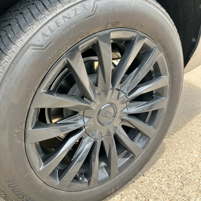 Cadillac Escalade wheel before cleaning, dull and dusty, in The Woodlands
