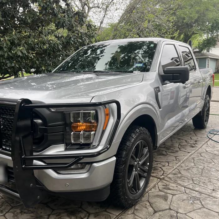 Silver Ford F-150 after a detail on a stamped-concrete driveway