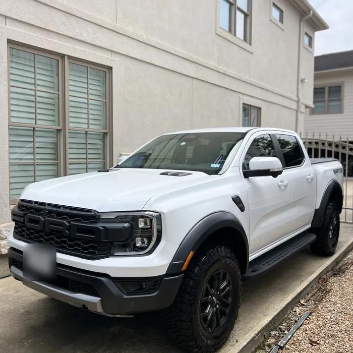 White Ford Ranger Raptor after a detail, on a side driveway