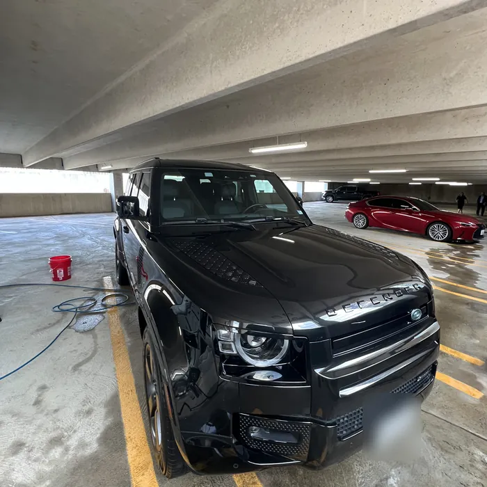 Black Land Rover Defender after a detail in an Uptown parking garage