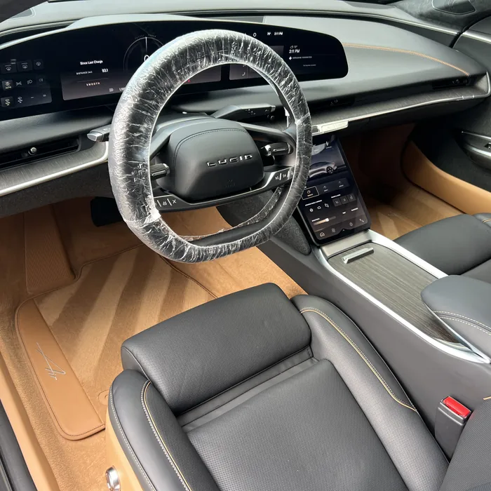 Lucid Air interior with tan carpets and dark seats after an interior detail