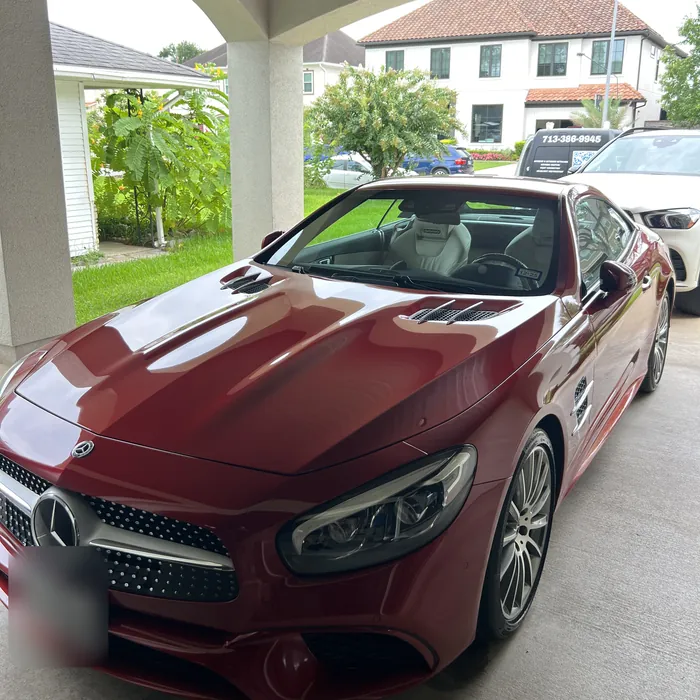Red Mercedes-Benz SL after a detail under a covered driveway