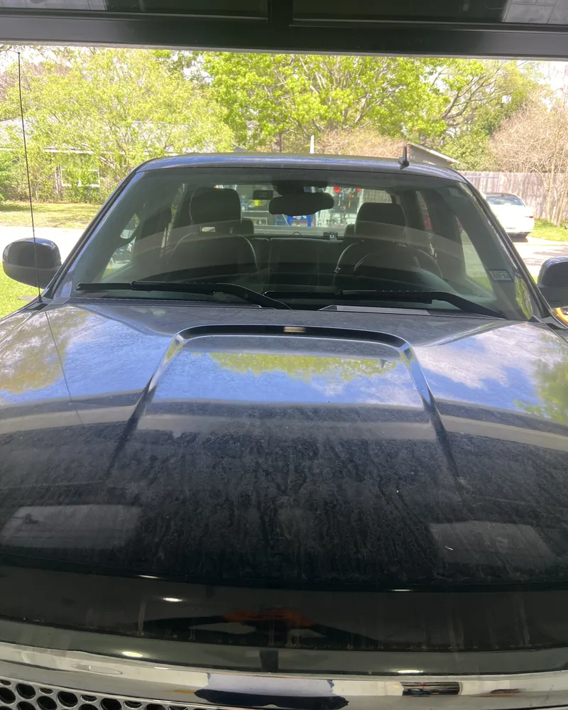 Black GMC Sierra Denali hood, dull and oxidized, before correction
