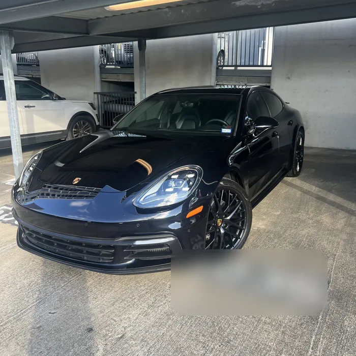 Dark blue Porsche Panamera after a detail in a covered parking space