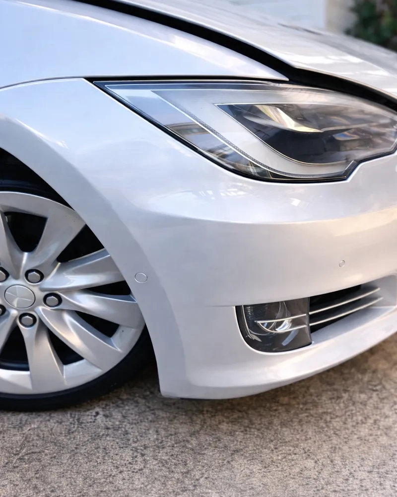 The same Tesla fender and bumper after the film was polished, with clarity restored