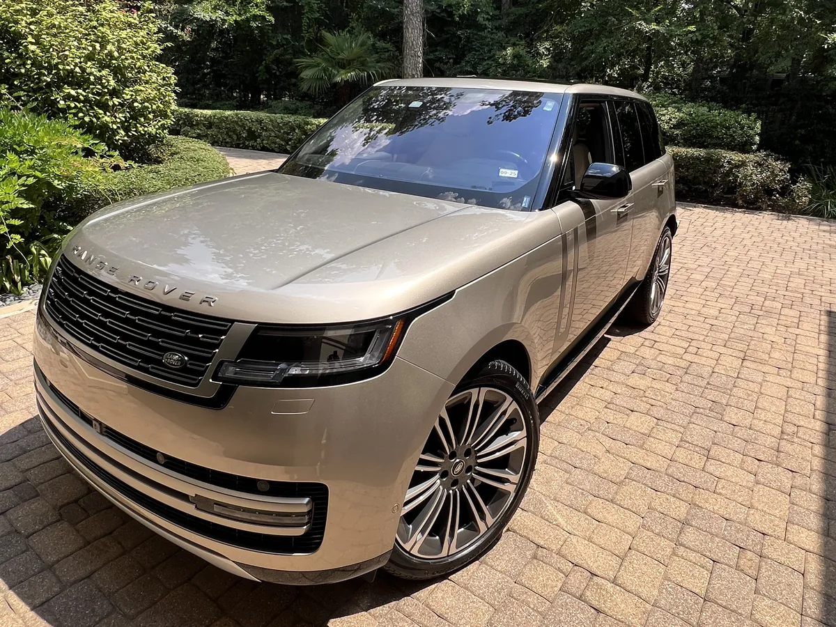 Champagne Range Rover after an Azul detail, on a brick driveway surrounded by trees in Memorial, Houston