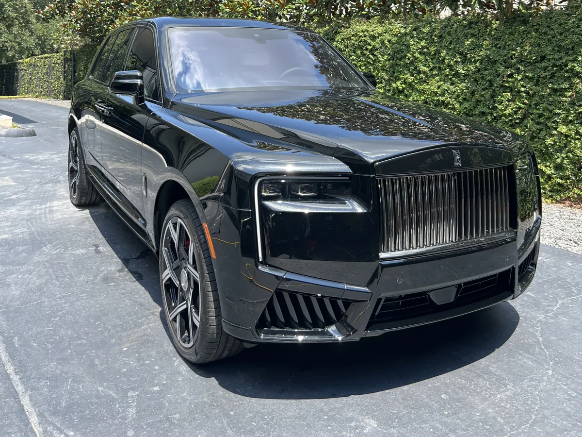 Black Rolls-Royce Cullinan after an Azul detail, parked in a River Oaks driveway beside a magnolia hedge