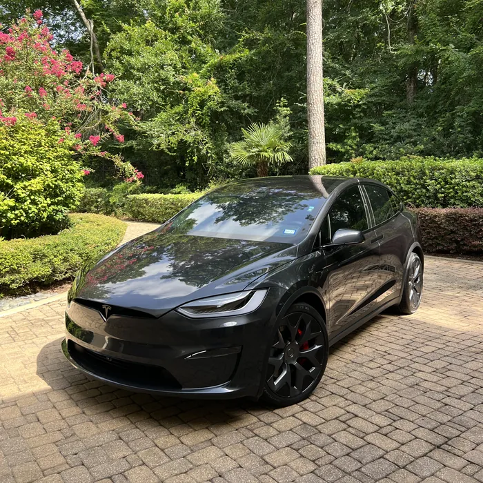 Gray Tesla Model X after a detail, on a brick driveway in Memorial
