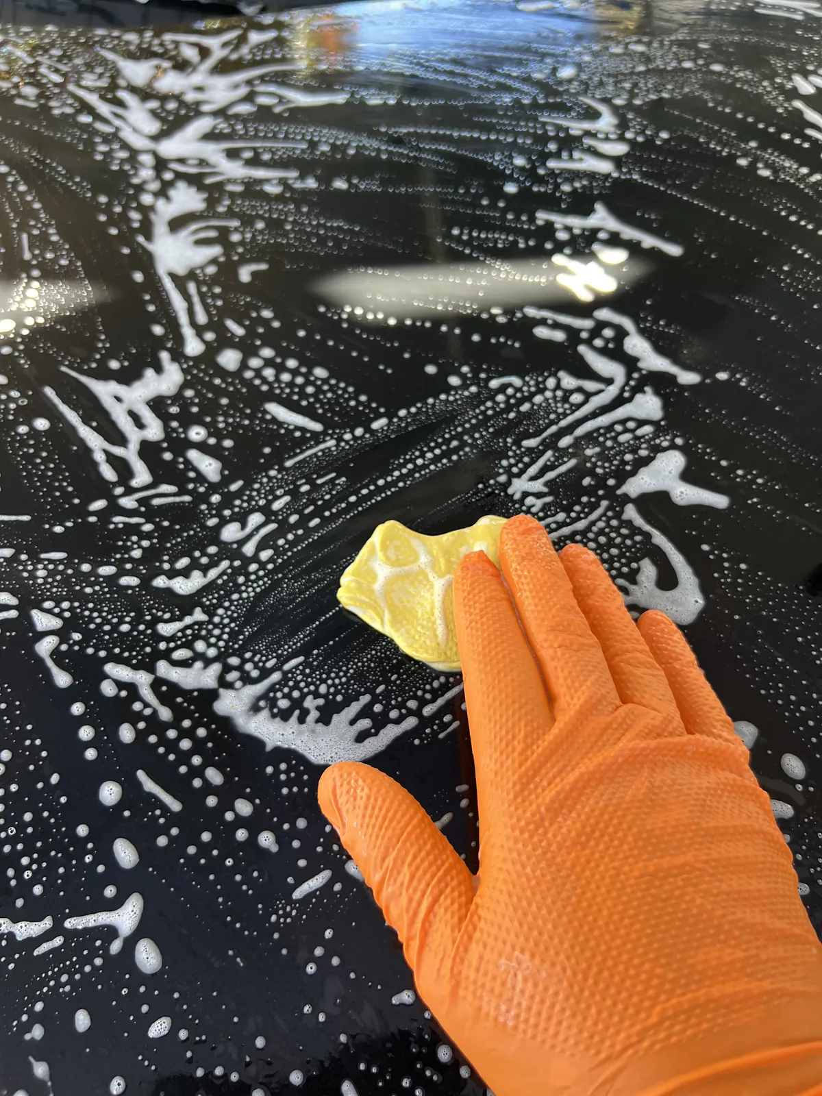 Careful contact washing of the black Toyota RAV4 during the first stage of tree residue removal
