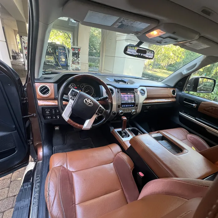 Toyota Tundra interior with brown leather after an interior detail, the Azul van in the background