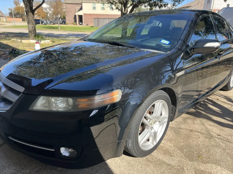 Black Acura TL with dull, swirled paint before correction