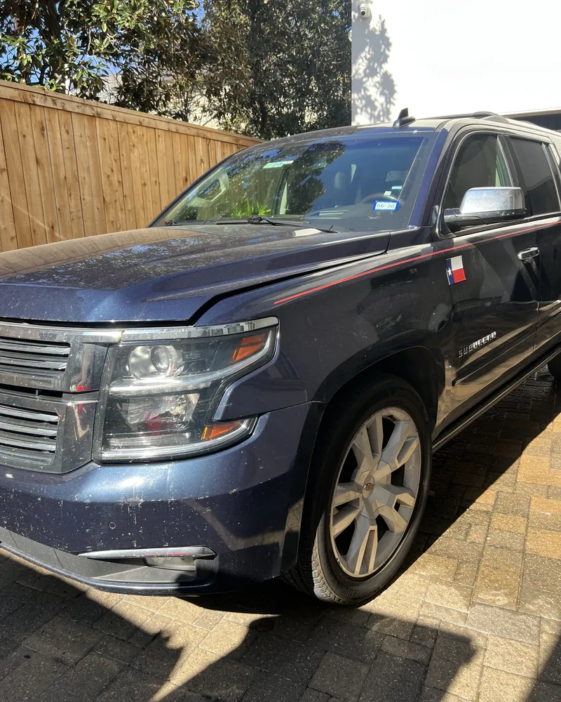 Dark blue Chevrolet Suburban with dull, contaminated paint before correction